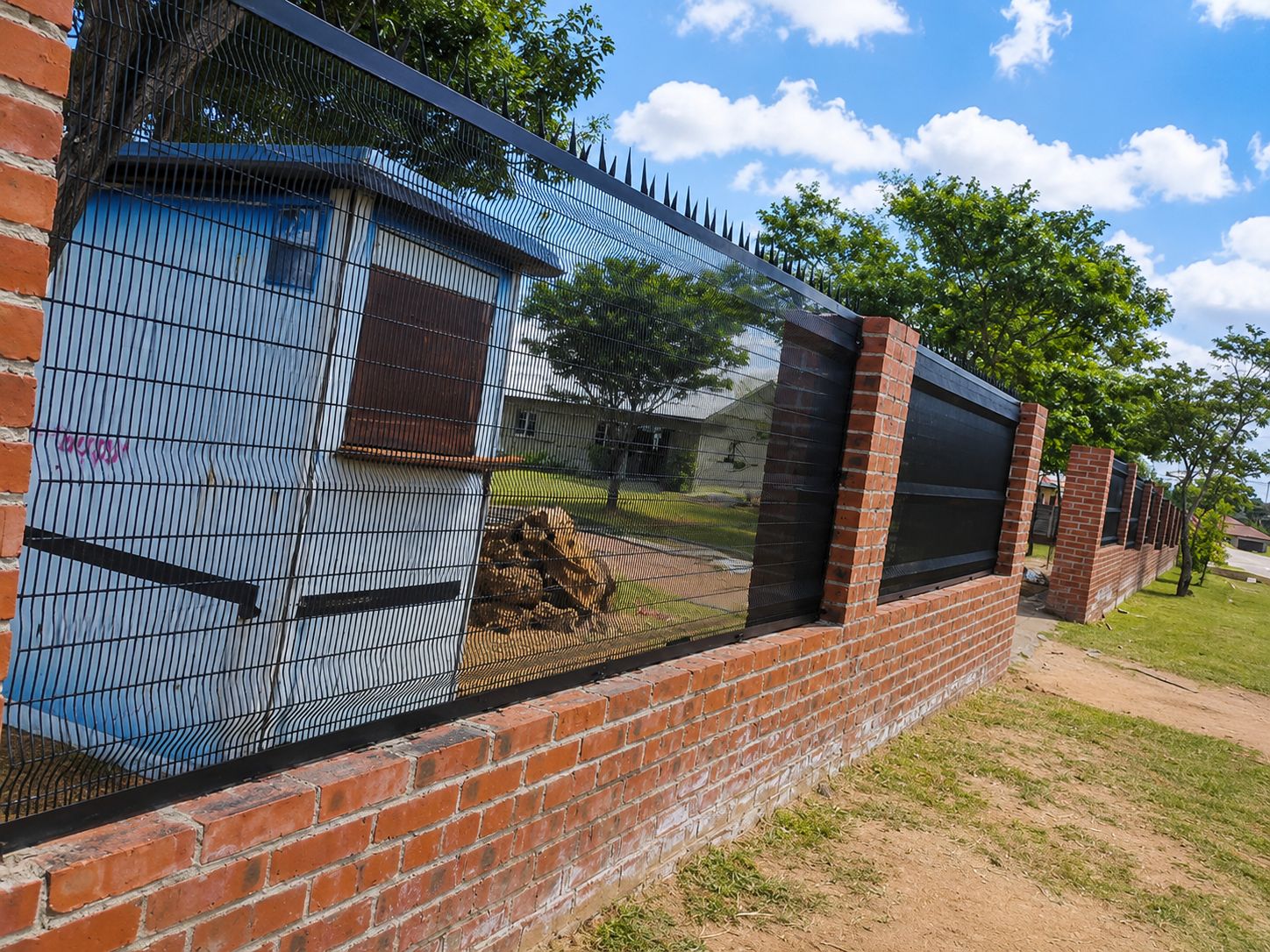 Clear view anti-climb mesh fence installed on a brick wall by RhinoFence