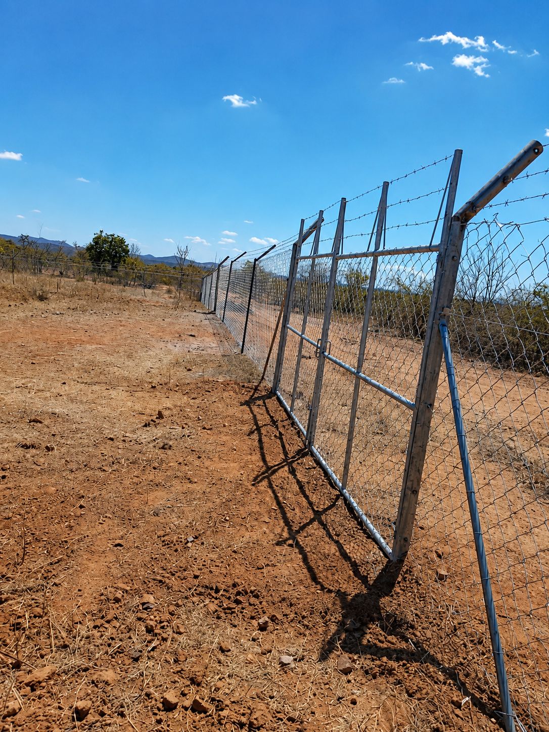 Diamond mesh fence line and gate installed on a Zimbabwean farm